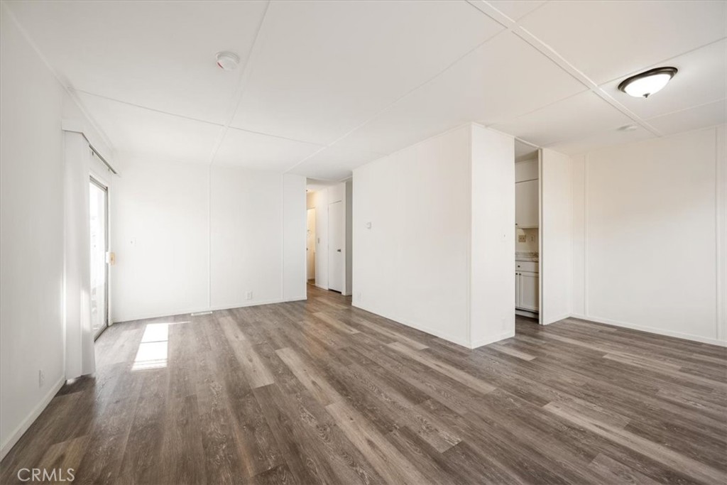 3210 Santa Maria Way, Unit 49 Santa Maria, CA 93455 - Photo 13 of 50 a view of an empty room with wooden floor and a window