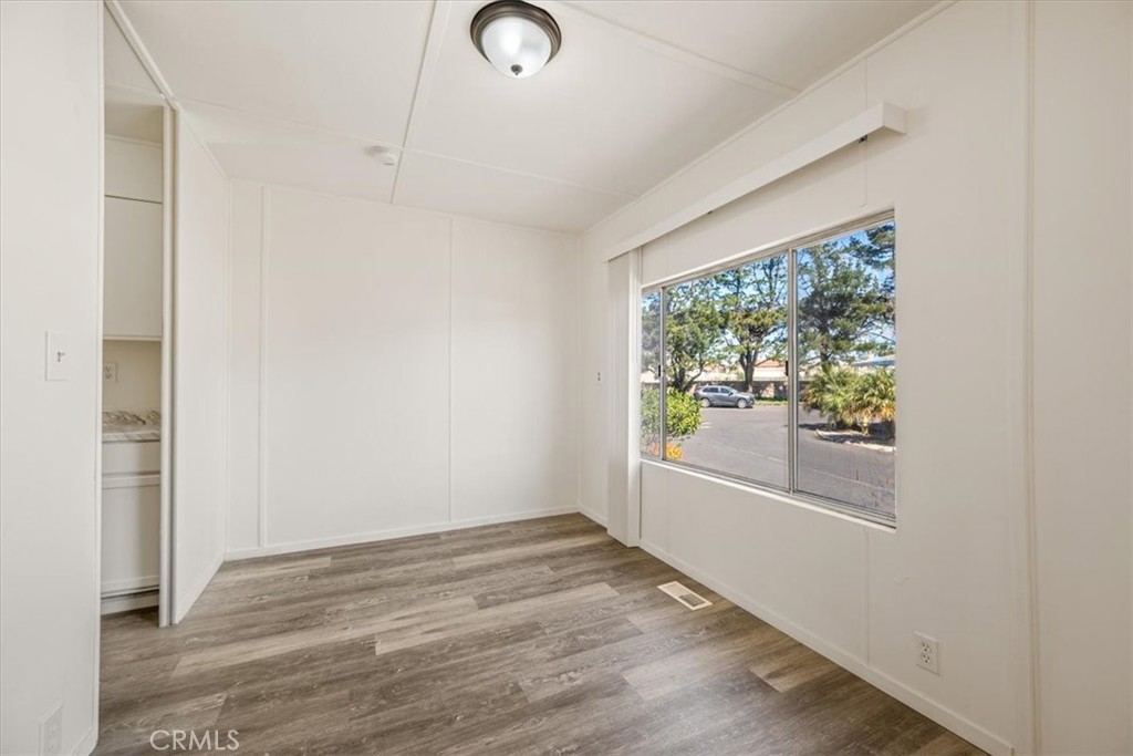3210 Santa Maria Way, Unit 49 Santa Maria, CA 93455 - Photo 14 of 50 an empty room with wooden floor and windows