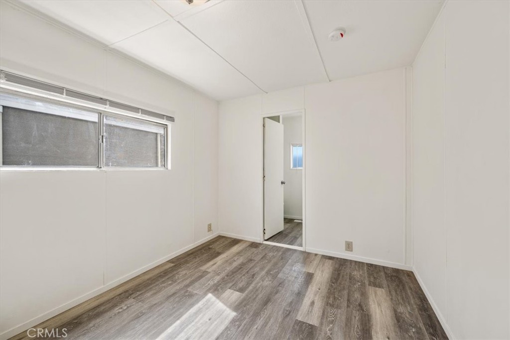 3210 Santa Maria Way, Unit 49 Santa Maria, CA 93455 - Photo 18 of 50 a view of empty room with wooden floor and fan