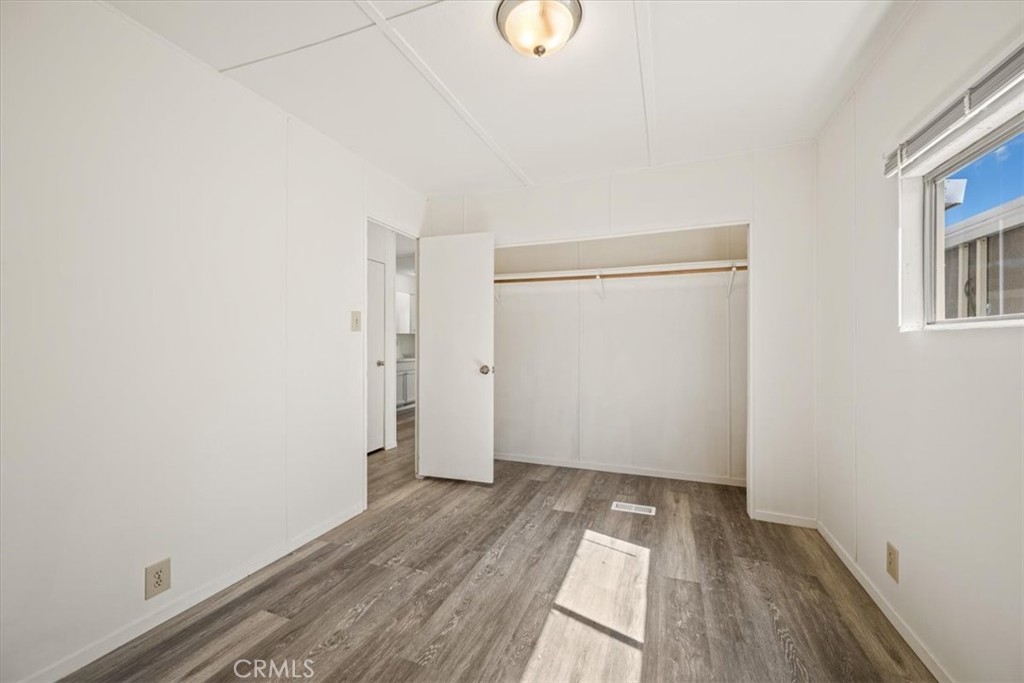 3210 Santa Maria Way, Unit 49 Santa Maria, CA 93455 - Photo 22 of 50 a view of a room with wooden floor and white walls