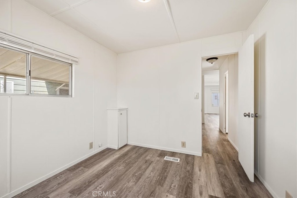 3210 Santa Maria Way, Unit 49 Santa Maria, CA 93455 - Photo 29 of 50 a view of a room with wooden floor and windows