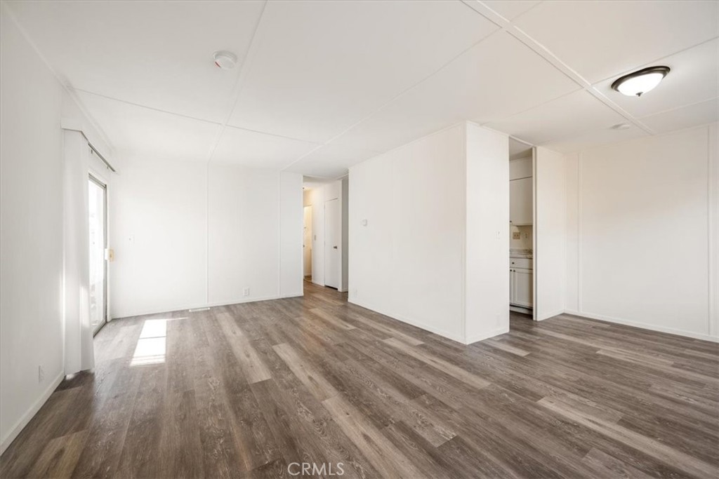 3210 Santa Maria Way, Unit 49 Santa Maria, CA 93455 - Photo 35 of 50 a view of an empty room with wooden floor and a window