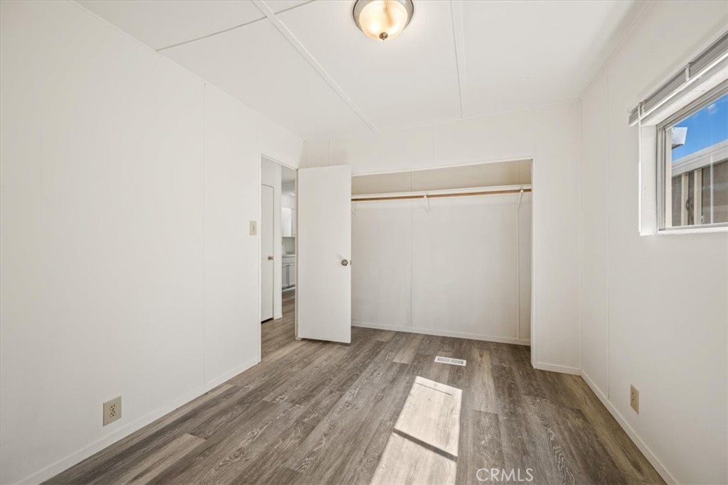 3210 Santa Maria Way, Unit 49 Santa Maria, CA 93455 - Photo 40 of 50 a view of a room with wooden floor and white walls