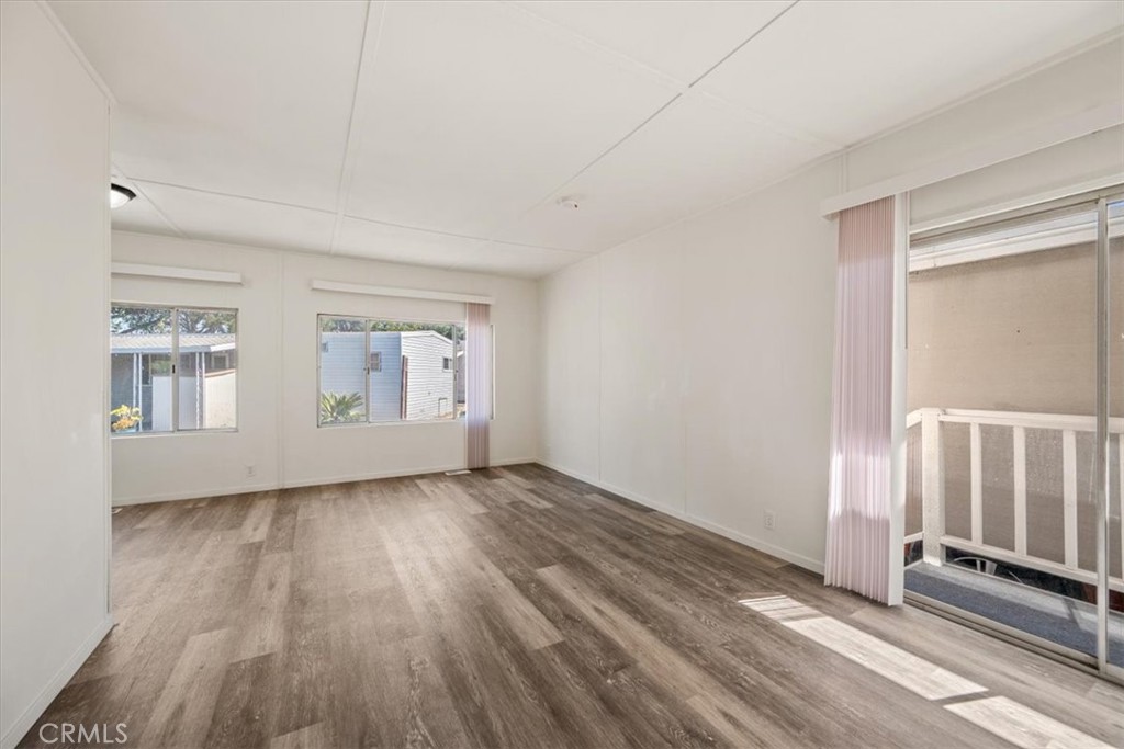 3210 Santa Maria Way, Unit 49 Santa Maria, CA 93455 - Photo 43 of 50 a view of an empty room with wooden floor and a window