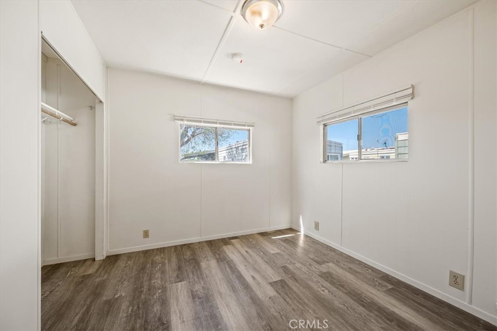 3210 Santa Maria Way, Unit 49 Santa Maria, CA 93455 - Photo 44 of 50 a view of an empty room with wooden floor and a window