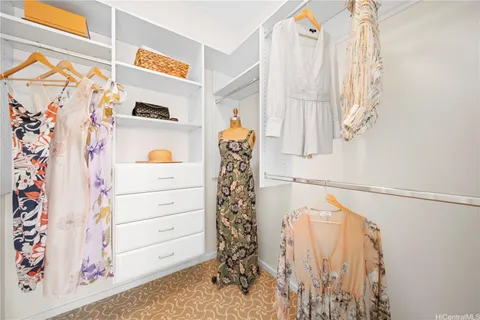a view of a closet with white walls