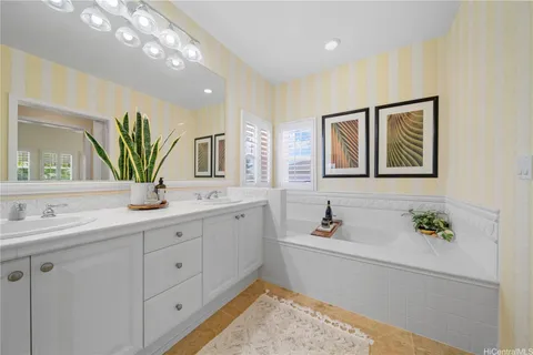 a bathroom with a tub sink and mirror