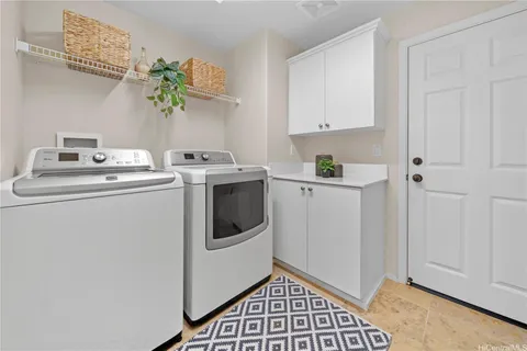 a view of storage and utility room with washer and dryer