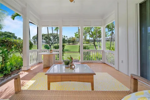 a view of a porch with furniture and garden