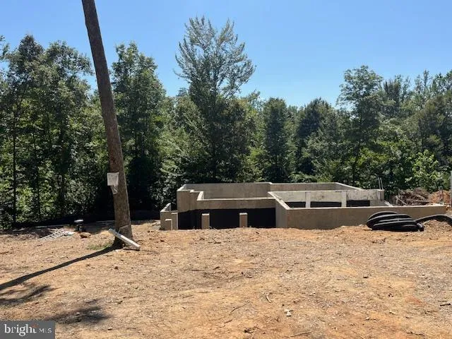 a view of pool with a yard