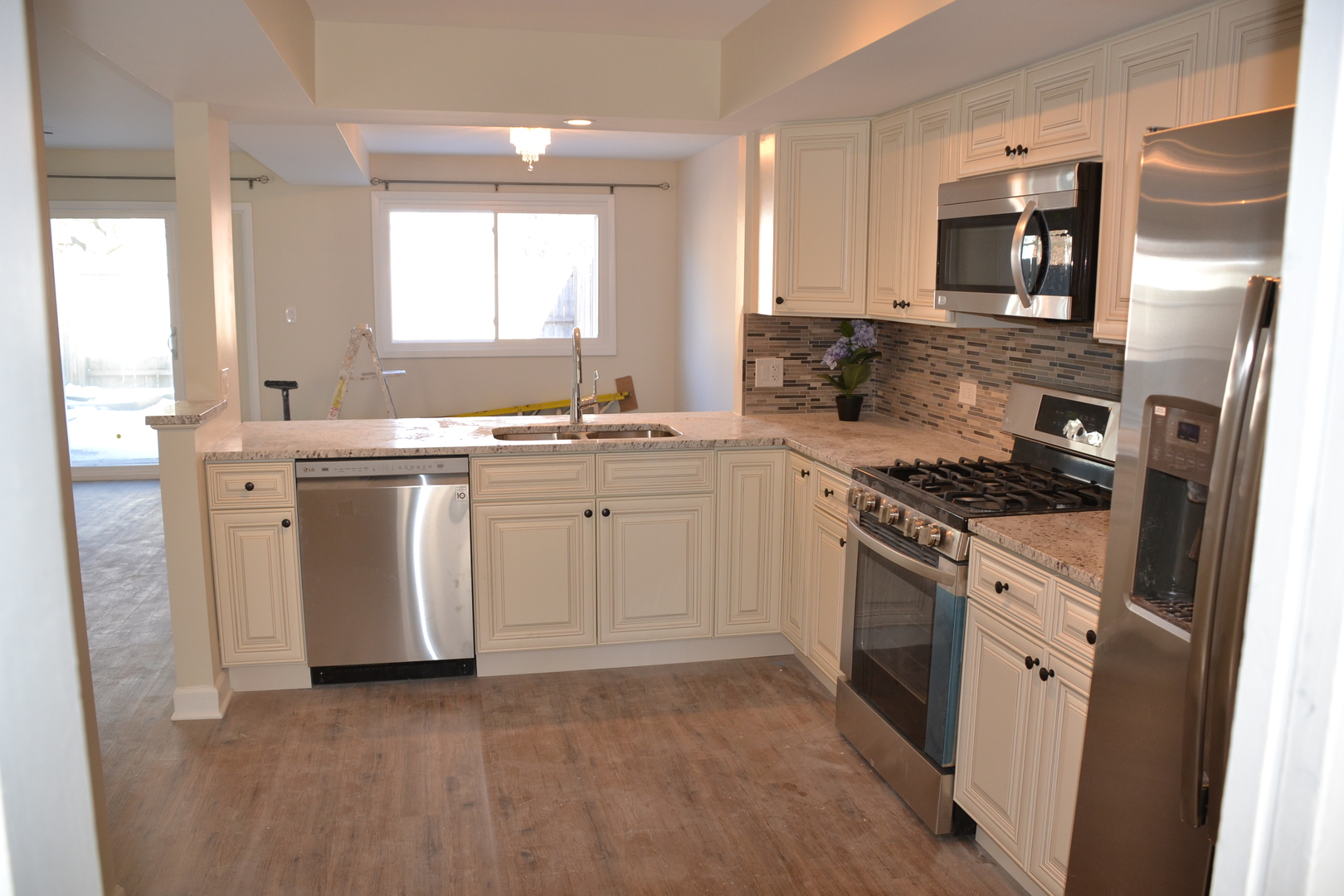 739 Hibbard Road Wilmette, IL 60091 - Photo 4 of 17 a kitchen with stainless steel appliances a stove sink and microwave