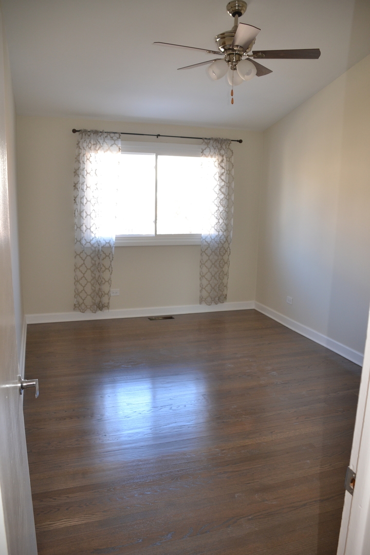 739 Hibbard Road Wilmette, IL 60091 - Photo 10 of 17 an empty room with wooden floor and windows