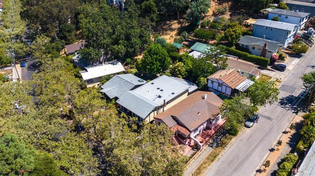 an aerial view of a house with a yard