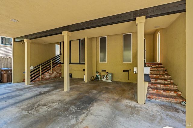 an empty room with stairs and a wooden door