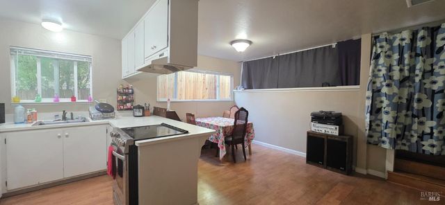 a kitchen that has a sink and a stove in it