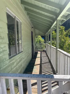 a view of a balcony with wooden floor