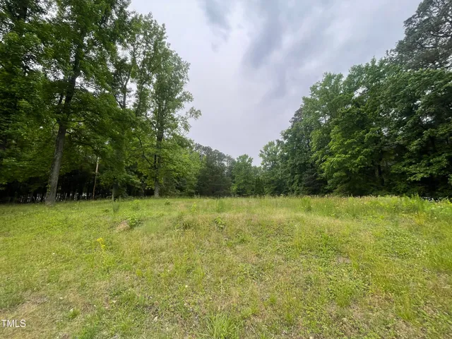 a living room with furniture wooden floor and a large window