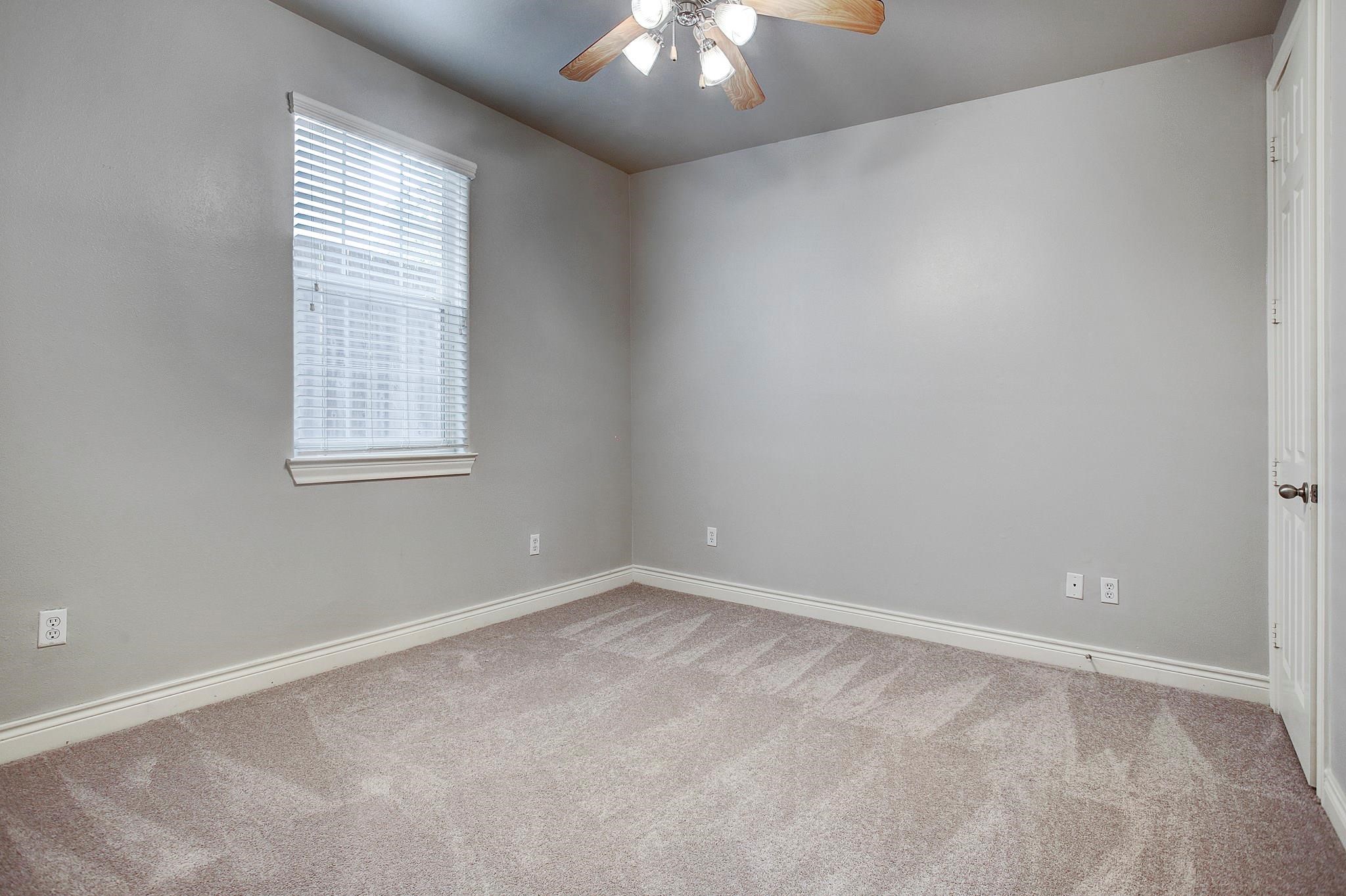 1602 Colorado Street Houston, TX 77007 - Photo 16 of 29 an empty room with windows and chandelier fan