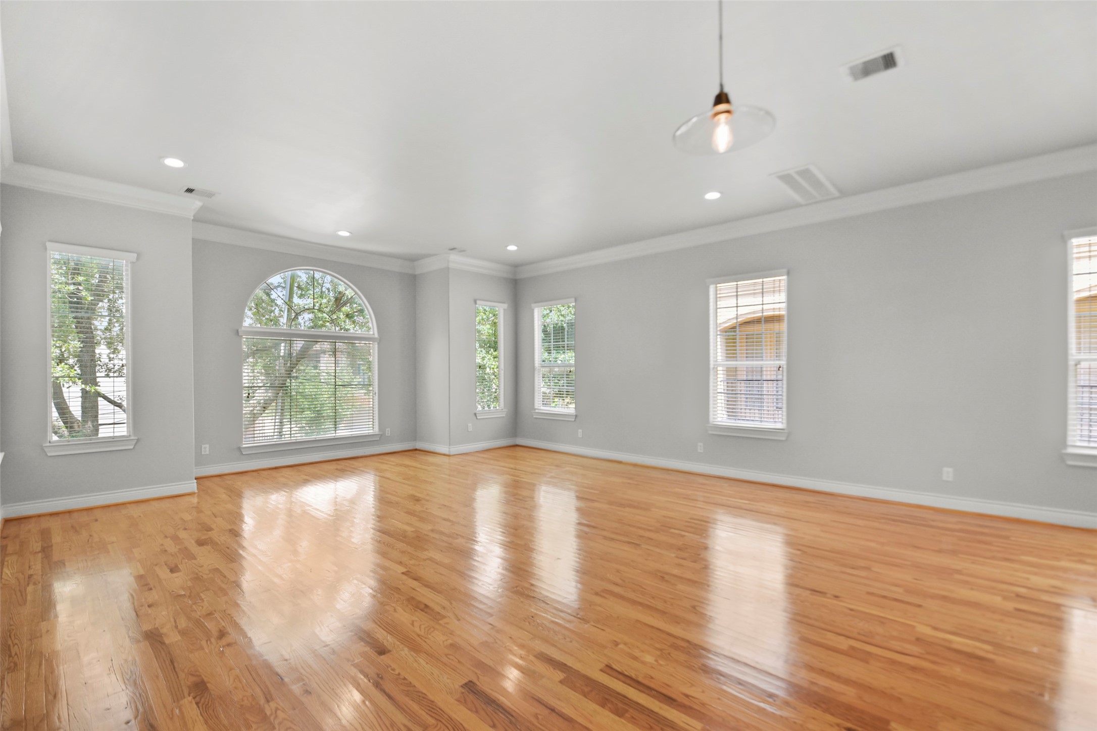 1602 Colorado Street Houston, TX 77007 - Photo 2 of 29 a view of an empty room with wooden floor and a window