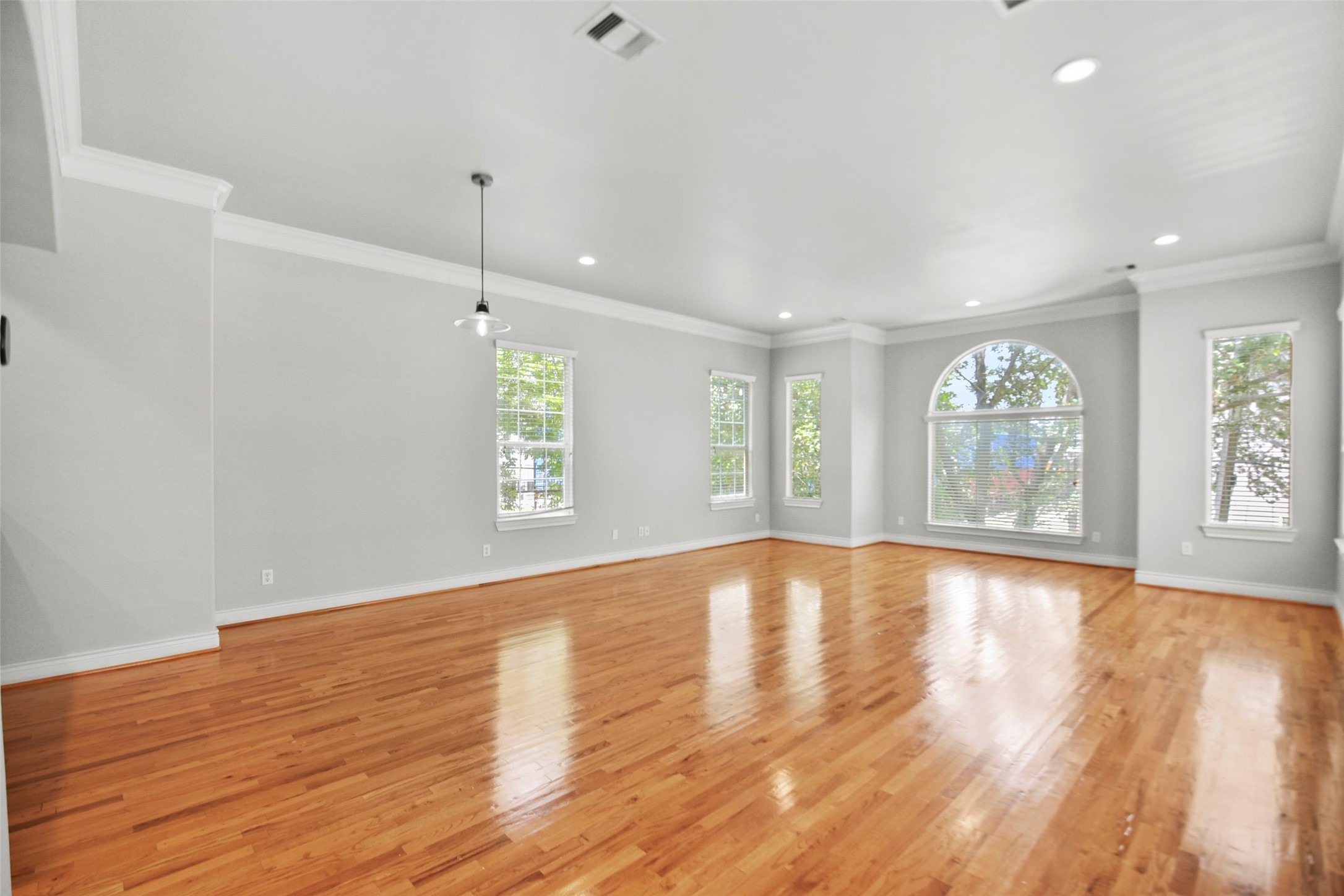 1602 Colorado Street Houston, TX 77007 - Photo 3 of 29 an empty room with wooden floor and windows