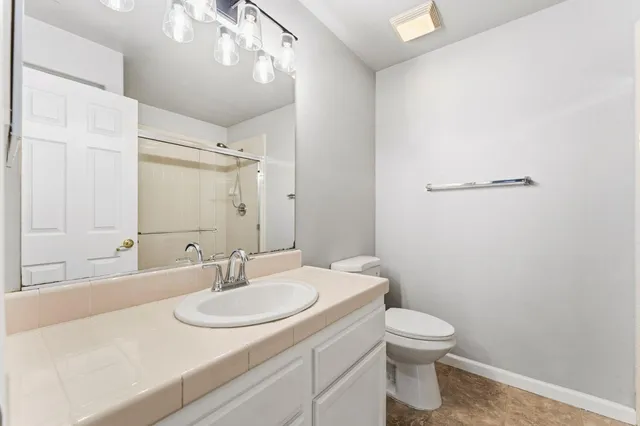 a bathroom with a sink toilet and a mirror