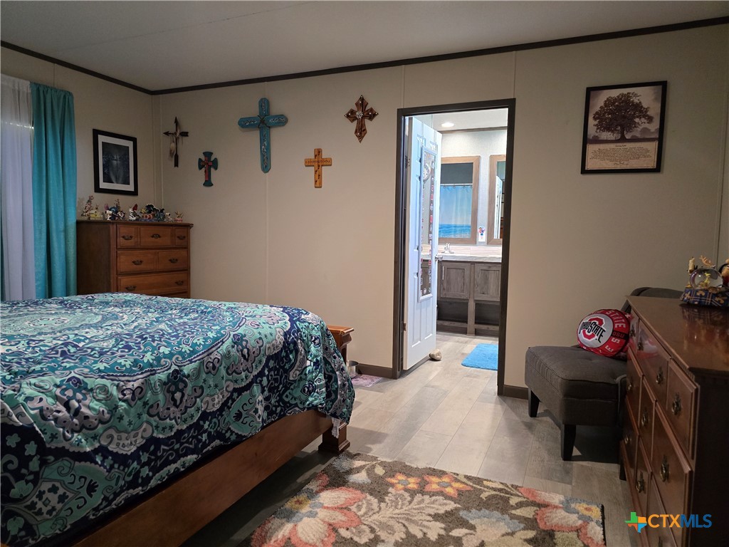 412 Coryell City Road Gatesville, TX 76528 - Photo 11 of 34 a bedroom with a bed and a view of kitchen