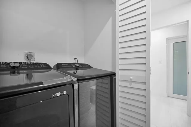 a utility room with washer and dryer