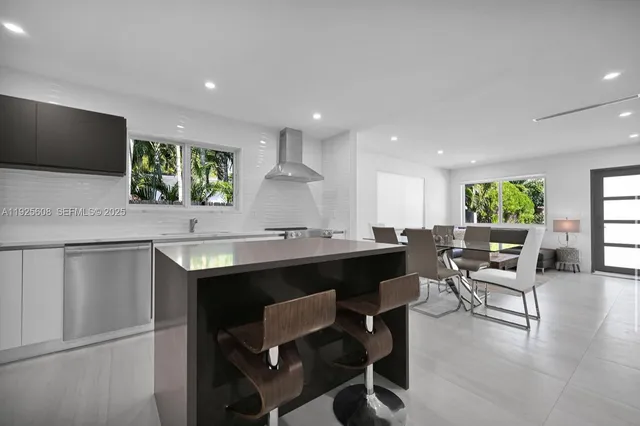 a kitchen with a table and chairs in it