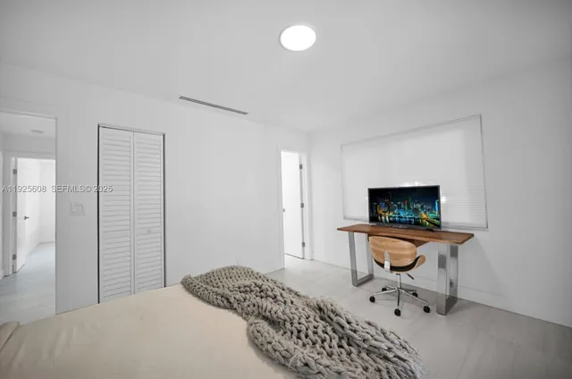 a bedroom with furniture and a window