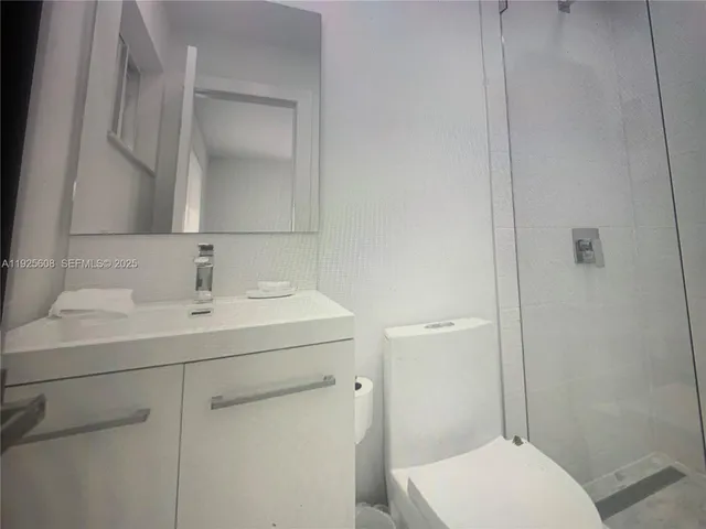a bathroom with a sink toilet and mirror