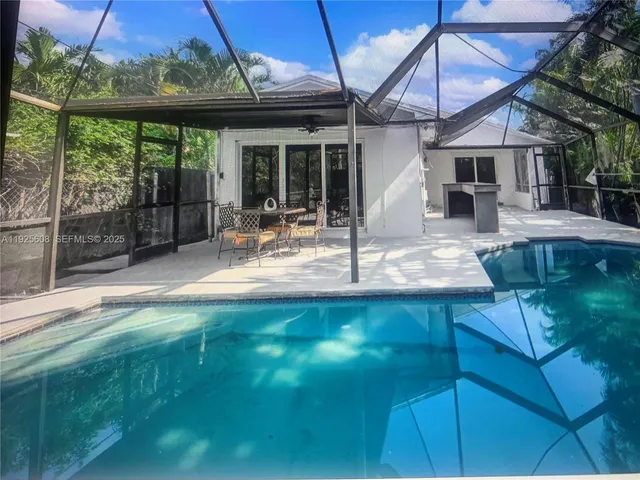 a swimming pool with outdoor seating yard and patio