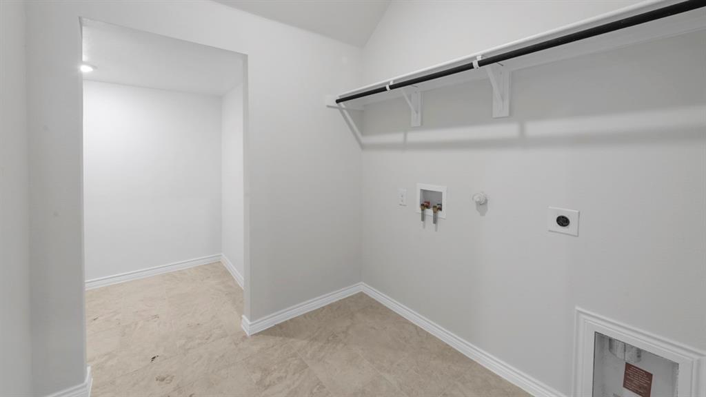 412 Carthage Street Caddo Mills, TX 75135 - Photo 16 of 32 Utility room featuring ceramic tile flooring, bright white walls, a built-in hanging rod, and appliance hookups