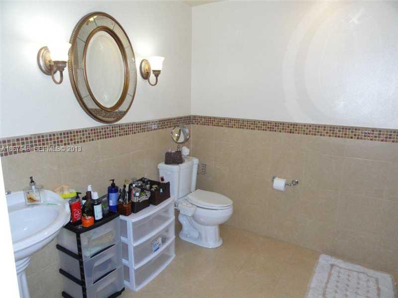 15636 Southwest 35th Terrace Miami, FL 33185 - Photo 14 of 18 a bathroom with a toilet a sink and a mirror