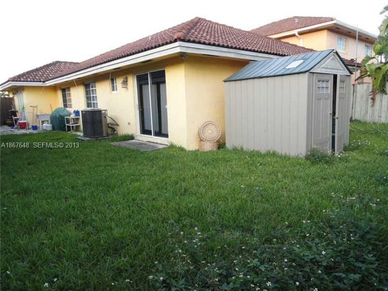 15636 Southwest 35th Terrace Miami, FL 33185 - Photo 16 of 18 a front view of a house with garden