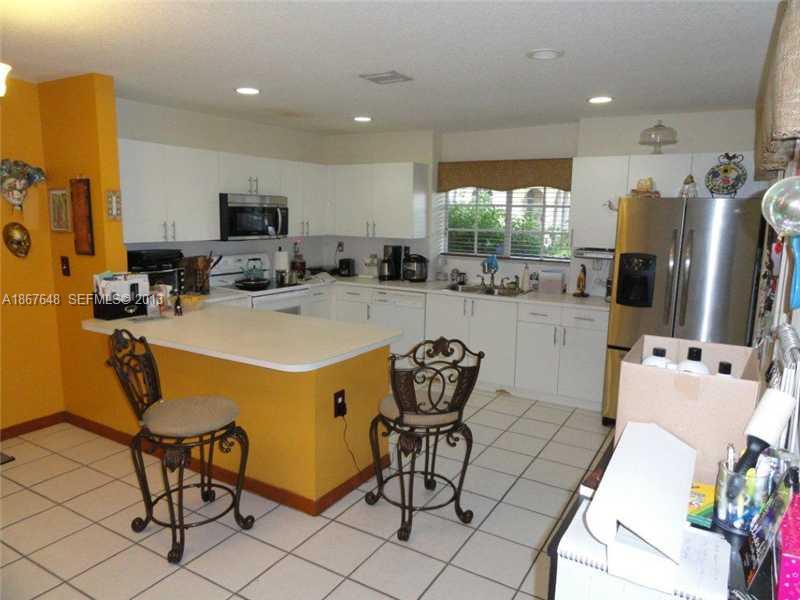 15636 Southwest 35th Terrace Miami, FL 33185 - Photo 3 of 18 a room with stainless steel appliances kitchen island granite countertop furniture and a view of living room