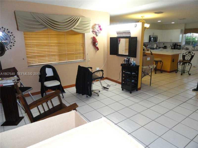 15636 Southwest 35th Terrace Miami, FL 33185 - Photo 5 of 18 a bedroom with furniture and a flat screen tv