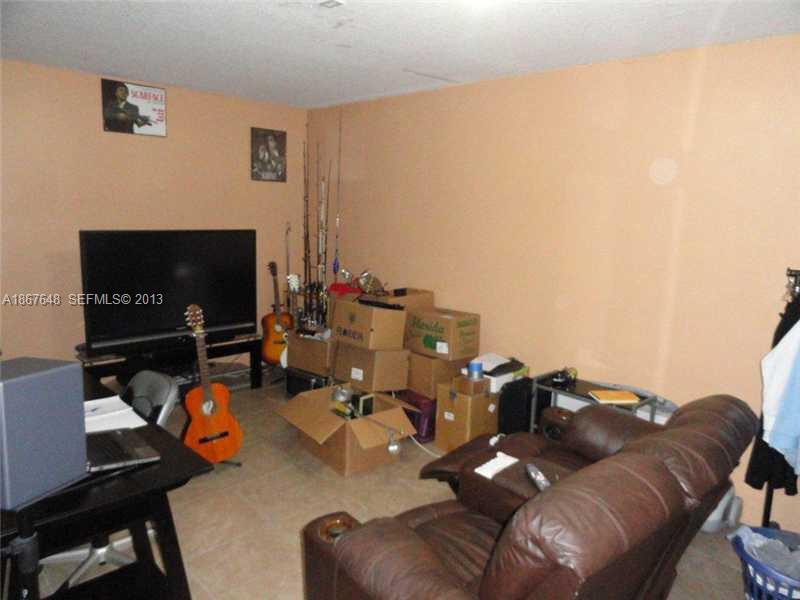 15636 Southwest 35th Terrace Miami, FL 33185 - Photo 6 of 18 a living room with furniture and a flat screen tv