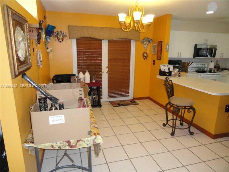 15636 Southwest 35th Terrace Miami, FL 33185 - Photo 7 of 18 a view of a dining room with furniture and chandelier