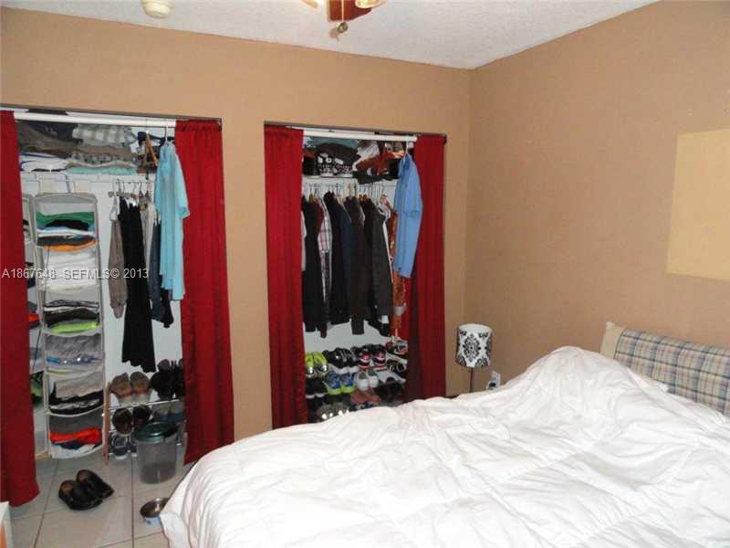 15636 Southwest 35th Terrace Miami, FL 33185 - Photo 9 of 18 a bedroom with a bed and a mirror
