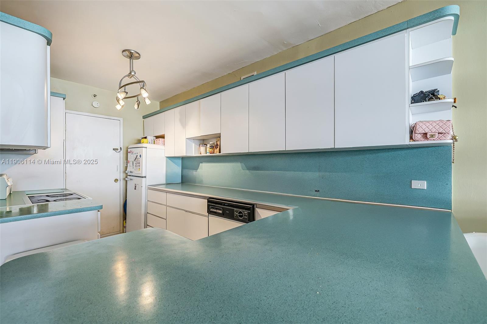 100 Lincoln Road, Unit 502 Miami Beach, FL 33139 - Photo 13 of 42 a kitchen with stainless steel appliances granite countertop a refrigerator a stove and a sink