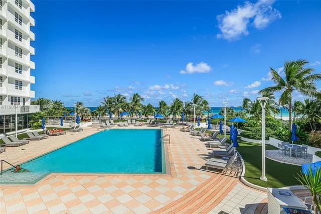 a view of a lake with couches and city view