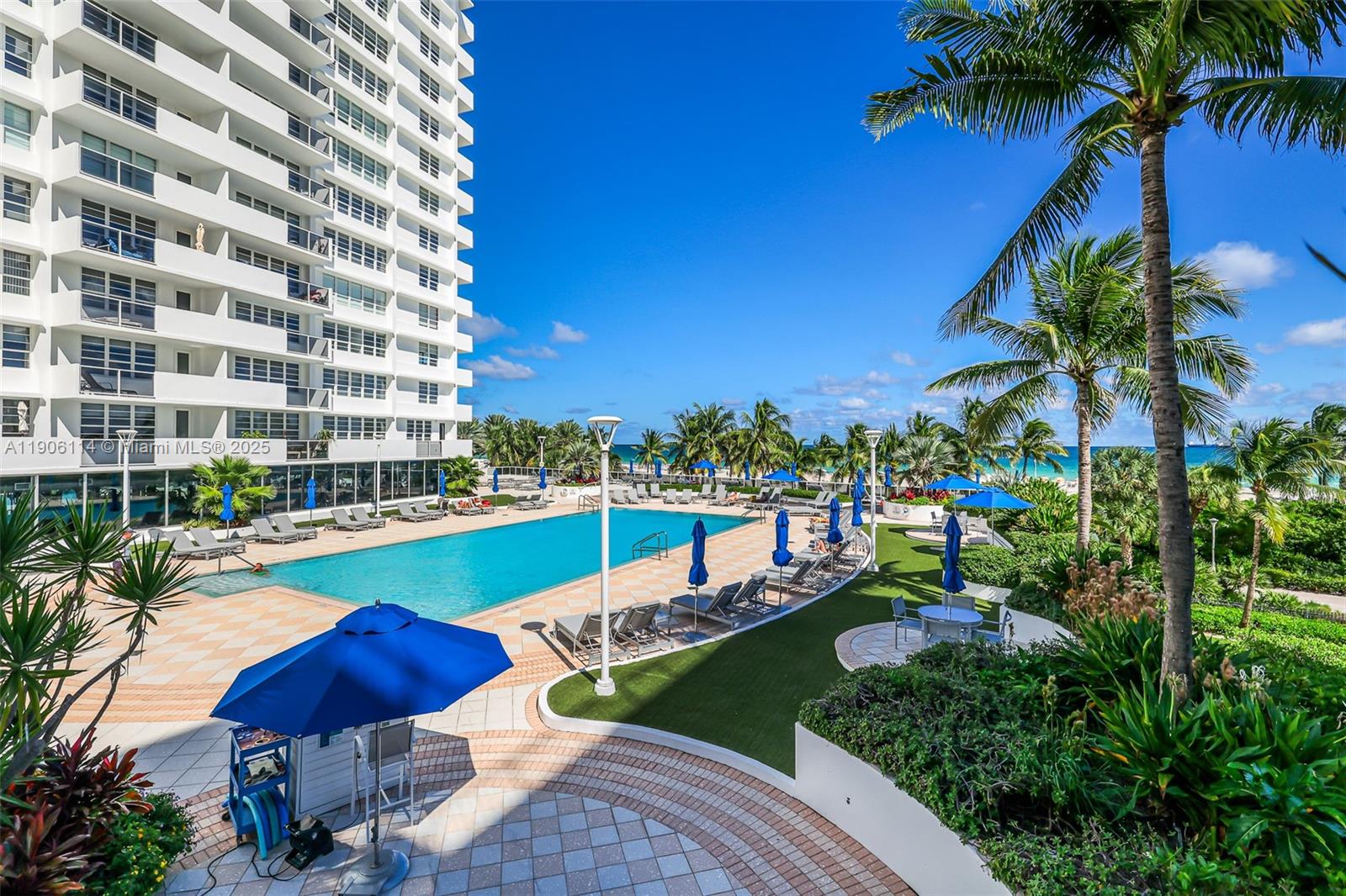 100 Lincoln Road, Unit 502 Miami Beach, FL 33139 - Photo 35 of 42 a view of a swimming pool with a table and chairs under an umbrella
