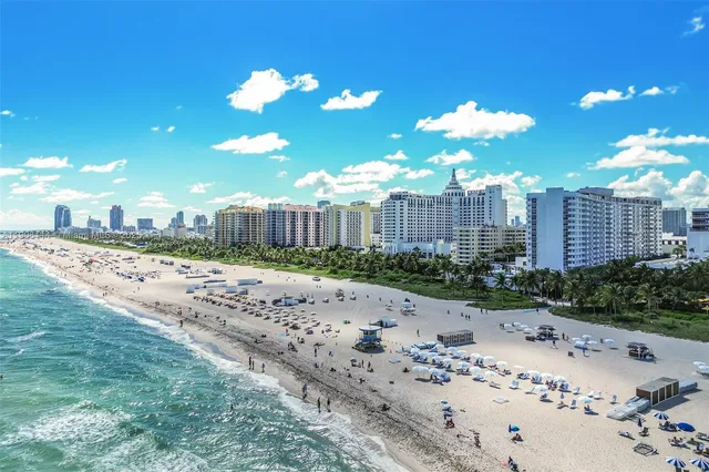 a view of a city with a big yard and large trees