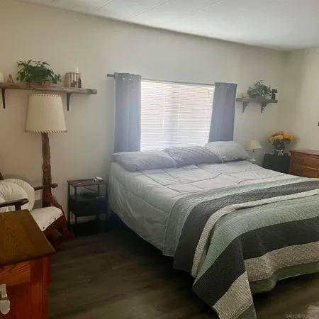 a bedroom with bed and window