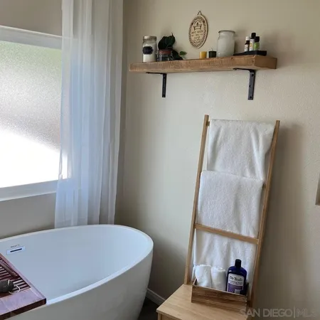 a bathroom with a bathtub and a window