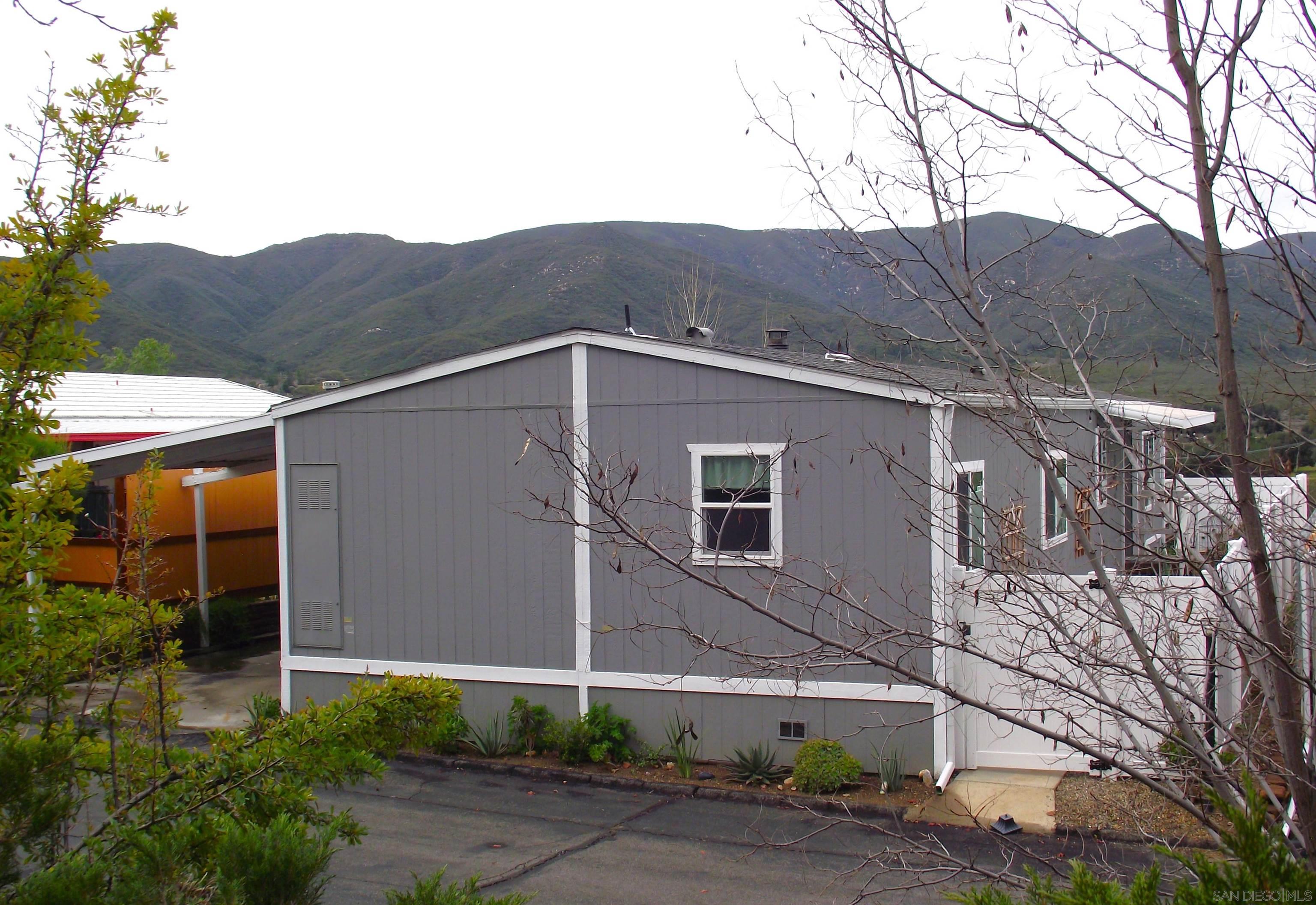 35109 Highway 79, Unit SPACE/ Warner Springs, CA 92086 - Photo 17 of 54 a view of a house with a yard and mountain view in back