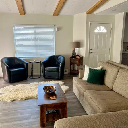 a living room with furniture lamp and window