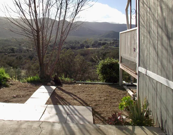 a view of a backyard with pathway