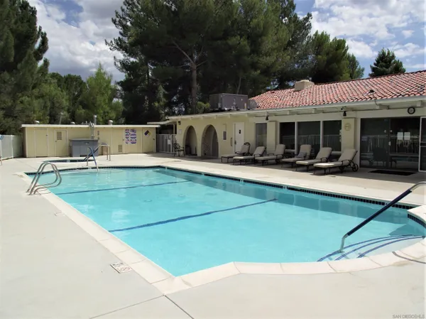 a view of a patio with chairs and a yard