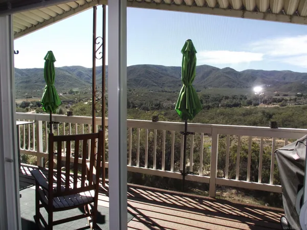 a view of a balcony with a table and chairs
